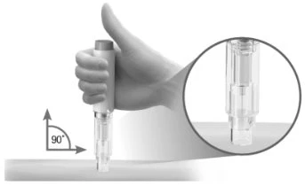 A hand holding a cylindrical medical device perpendicular to a surface, with a magnified detail of the device tip