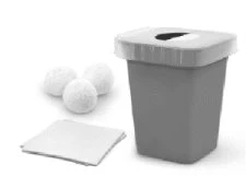 Three white round pills next to a gray container with a lid and a white sheet of paper on a neutral background