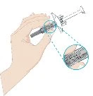 A hand holding a syringe with a circular magnifier showing in detail the graduated scale and dosing mechanism of the device