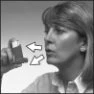 Woman holding an inhaler near her mouth with two white arrows indicating the movement of the