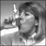 A woman with light hair holds a container to her mouth to drink, with a white arrow pointing toward the