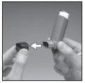Two hands demonstrate how to insert a small black component into the base of a cylindrical medical device, as indicated by a white arrow