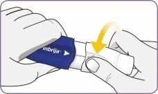 Two gloved hands removing the white protective cover from a blue and white medical device, with a curved yellow arrow indicating the movement