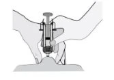 Two hands holding a syringe with needle to inject a drug at the top of a skin elevation or body part