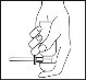 A hand holding a syringe vertically, with the thumb positioned on the plunger for drug administration
