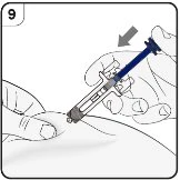 A hand holds a syringe at an angle while the