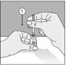 Two hands prepare the medication, one holds a small vial steady while the other