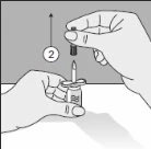 One hand holding a vial while the