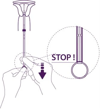 Diagram showing two hands holding a medical device with an enlargement highlighting the