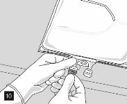 Two hands holding and manipulating the bottom part of a medical container with small circular caps or components being applied