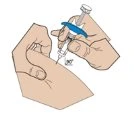 Two hands holding a syringe with a needle and a blue device to inject the medication into the skin of the arm or thigh