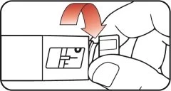 A hand pressing downward on a rectangular component of a medical device, following the direction indicated by a curved red arrow