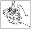 Two hands gathering a mass of small white round spheres or pills in a gesture of collecting or holding