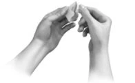 Two hands grasping and breaking a small white object or tablet in half on a neutral background