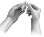Two hands holding and carefully breaking a tablet or medicinal fragment into two pieces