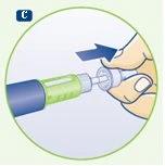 A hand holding a green and blue cylindrical medical device with a blue arrow indicating the insertion or pressing motion downward