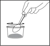 A hand holds a teaspoon and moves it with a rotating motion around