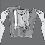 Two hands holding open a plastic pouch to remove a vial containing liquid with a needle attached at the base