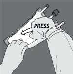 Two hands holding a flat medical device while one hand firmly presses the top following the directional arrow