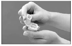Two hands hold and open a white medical device consisting of a main body and a removable lid on a gray background
