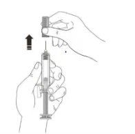 A hand removing the protective cap from a needle attached to a syringe held firmly in the other hand