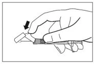 A hand pressing down with the thumb on a syringe plunger