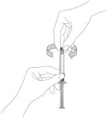 Two hands holding a syringe while a curved arrow indicates rotating the top part to prepare the medication