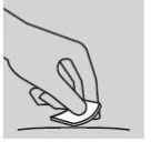 A hand holds a small patch or adhesive disc and gently applies it to a curved skin surface