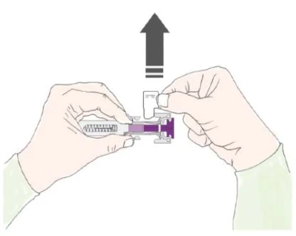 Two hands holding a medical device with purple liquid inside at