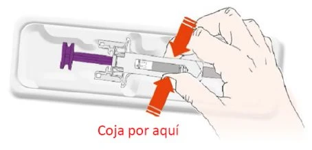 A hand holding a prefilled syringe at