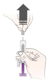 Two hands manipulating a syringe with the needle pointing toward the