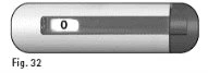 Horizontal gray and white capsule with a central transparent window showing the number 0 on a dark background and the label Fig. 32