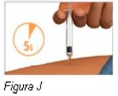 A hand holding a syringe vertically while administering an injection