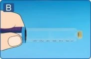 A hand holding horizontally a transparent syringe with black graduations on a blue background with the letter B in the top left corner