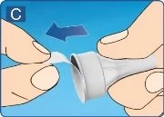 Two hands removing the white protective shield from a medical device on a blue background with a blue arrow pointing to the left