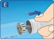 A hand rotating and removing a white cap from a cylindrical medical device on a blue background indicated by a blue arrow