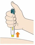 A hand holding vertically a black and white medical device to inject a drug into the arm skin with an orange arrow pointing downward