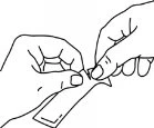 Two hands carefully opening the packaging or wrapper of a medical product by gently pulling the sides