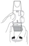 A hand holding a cylindrical medical device while the