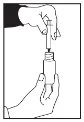 A hand holds a syringe with needle pointing upward