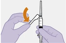 Two gloved hands holding a syringe while one hand rotates it downward...