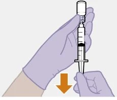 A gloved hand holding a syringe vertically with an orange arrow pointing downward indicating the aspiration movement