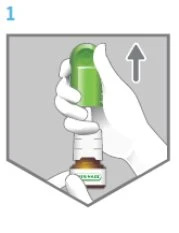A hand holds a green and white medical device pointing upwards