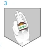 A gloved hand holds a dark medicine bottle with a dropper for administering eye drops