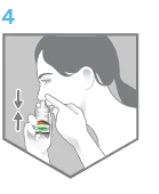 Side view of a person holding a spray bottle near the nose with vertical arrows indicating the inhalation motion
