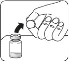 Una mano tiene un tappo circolare e lo solleva con un movimento verso l'