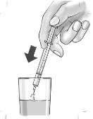 A hand holding a syringe with the needle pointing downward to aspirate liquid from a small transparent container, with a black arrow indicating the direction