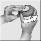 Two hands hold and rotate a circular device to the right in the direction indicated by a white curved arrow