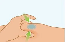 A hand pinches the skin to create a fold to prepare the injection site