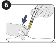One hand holding a syringe with yellow liquid and the tip directed toward the skin at the injection site with a blue arrow pointing downward